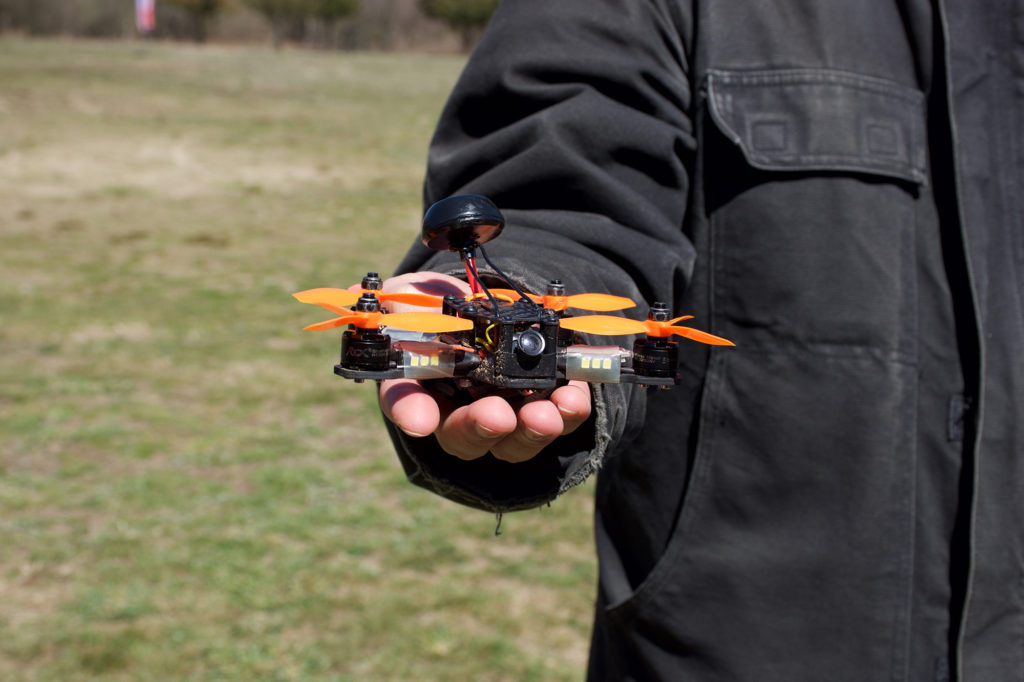 A standard hobby-grade drone with a low-resolution camera.